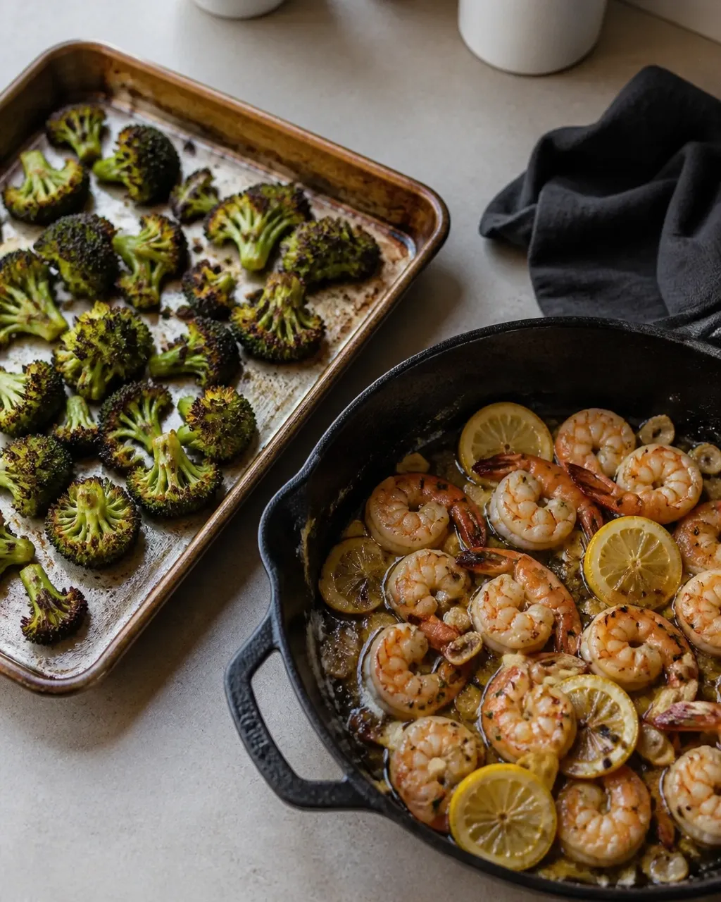 Roasted broccoli and lemon garlic shrimp in a skillet and on a sheet pan